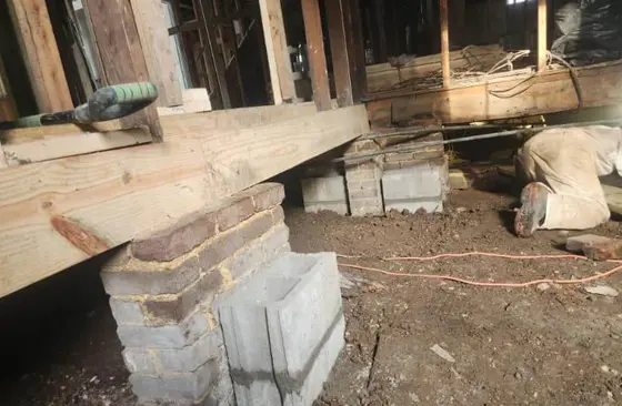 Foundation pier and block replacement under home during structural repair service