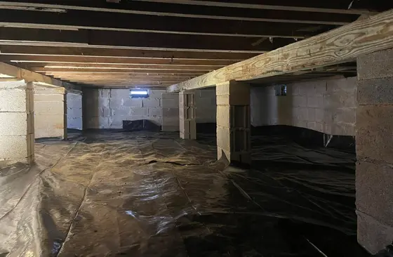 Foundation stabilization and crawlspace repair with new support beams and vapor barrier