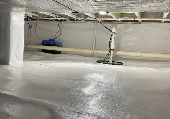 Crawlspace encapsulation with white vapor barrier and sump pump installation in Paducah KY home