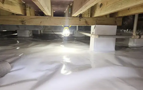 Crawlspace encapsulation service with sealed vapor barrier and moisture control lighting in Paducah Kentucky
