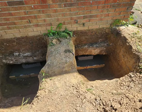 Foundation pier installation and excavation for structural stabilization in Paducah Kentucky