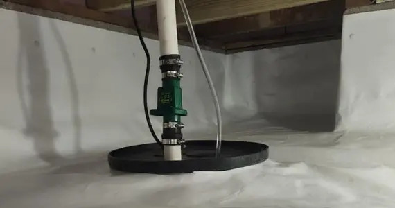 Sump pump system installed in encapsulated crawlspace for groundwater removal